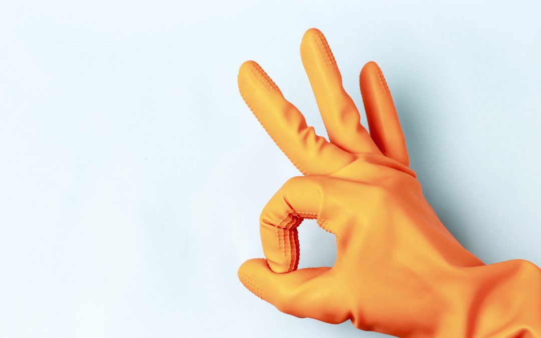 Tips to help with searching for commercial cleaning companies and how to make sure you choose the best commercial cleaning company, photo of hand with orange rubber cleaning glove on giving hand gesture for satisfaction