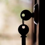 Image of open door with keys in lock hanging down negligence of office building security janitorial companies leaving doors unlocked