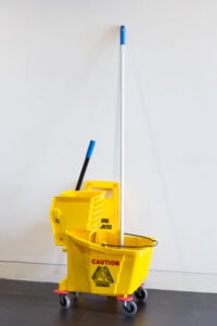 Why choose Sparkle and Shine Cleaning Company for commercial janitorial services in Columbia, SC image of yellow commercial cleaning mop bucket and mop